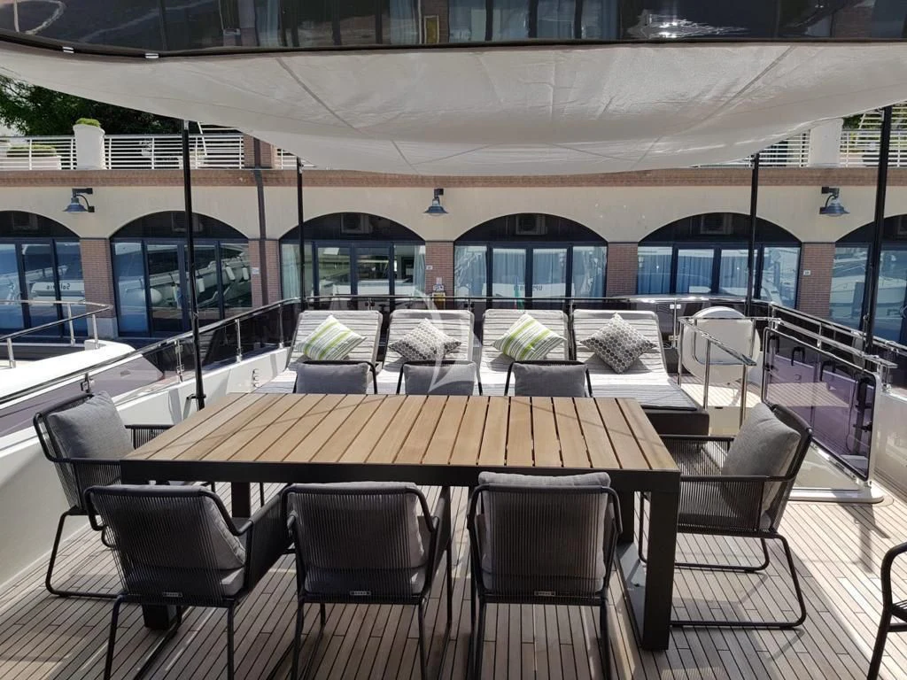 a table with chairs around it aboard NINETEEN Yacht for Sale