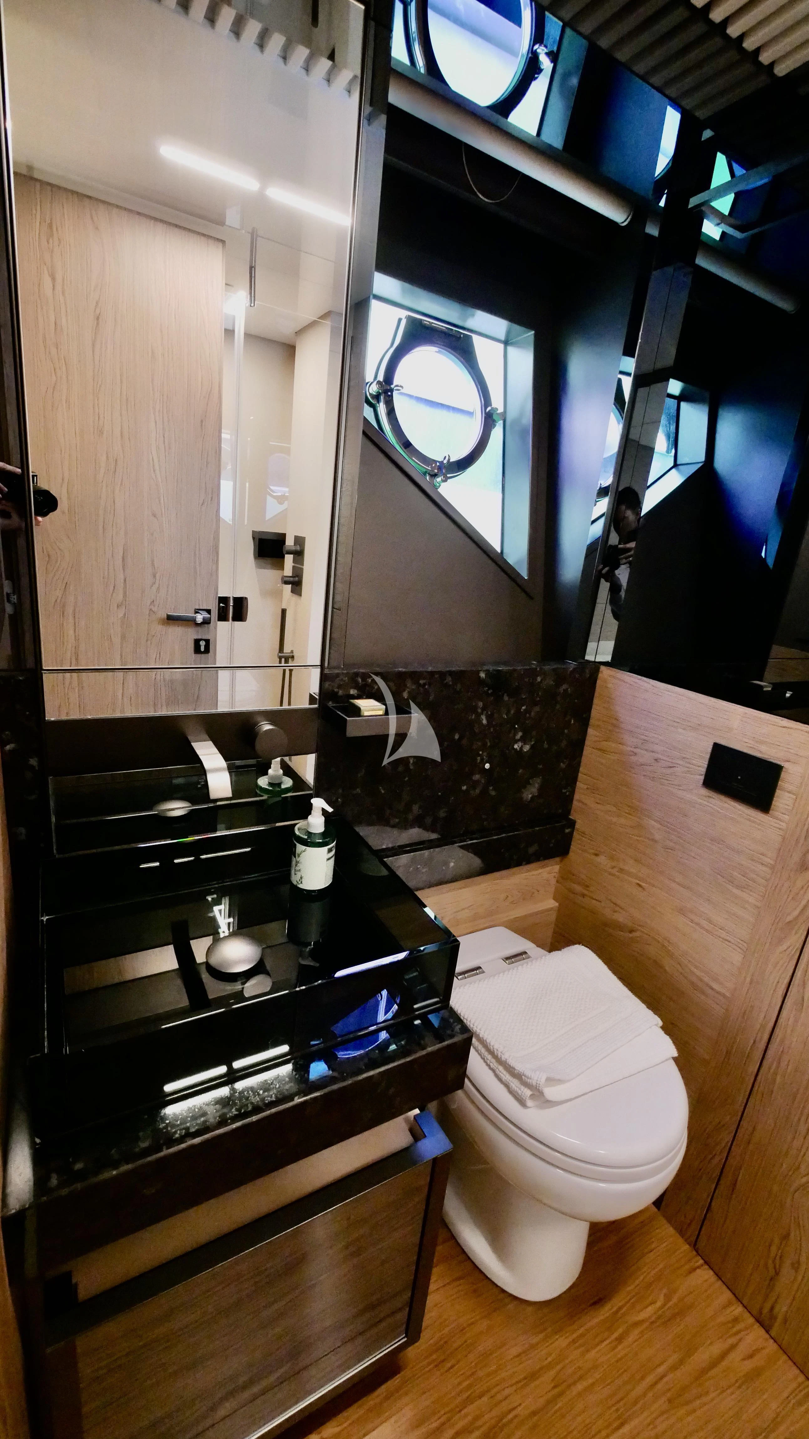 a bathroom with a toilet and a sink aboard NINETEEN Yacht for Sale