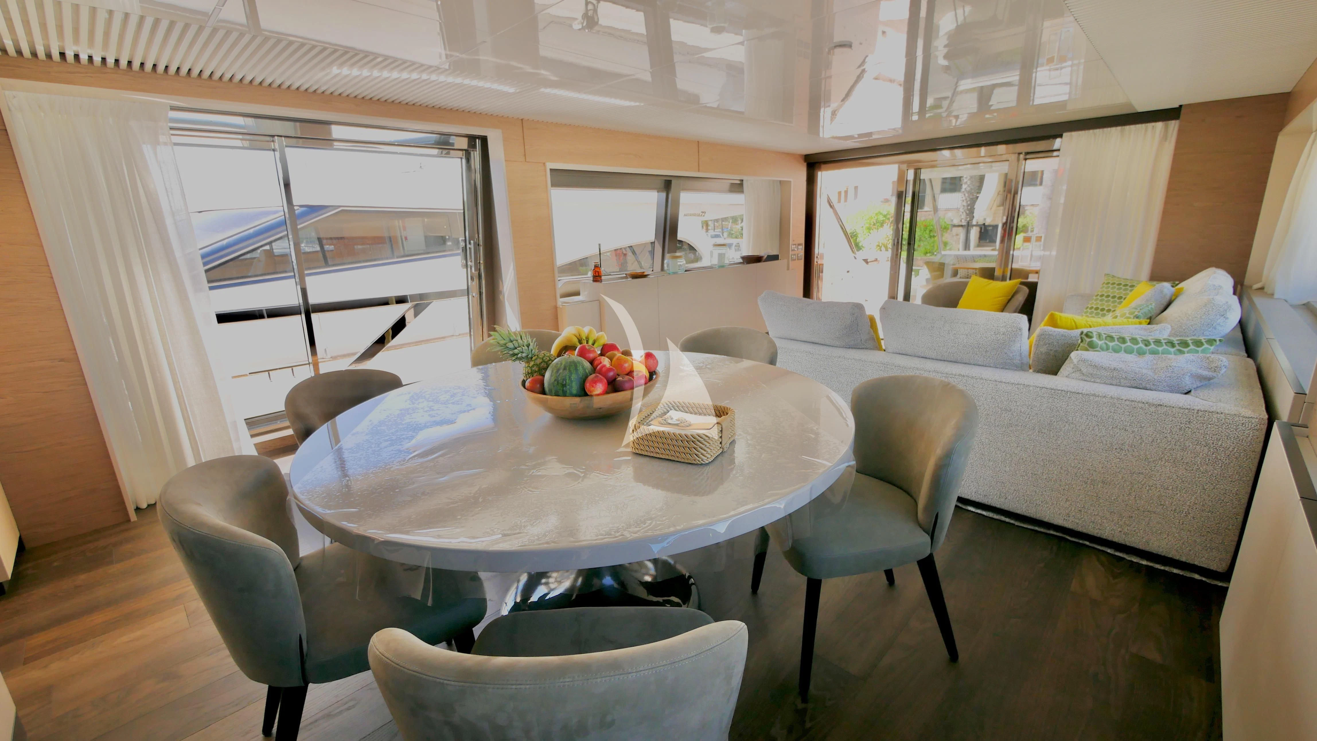 a living room with a couch and a table aboard NINETEEN Yacht for Sale