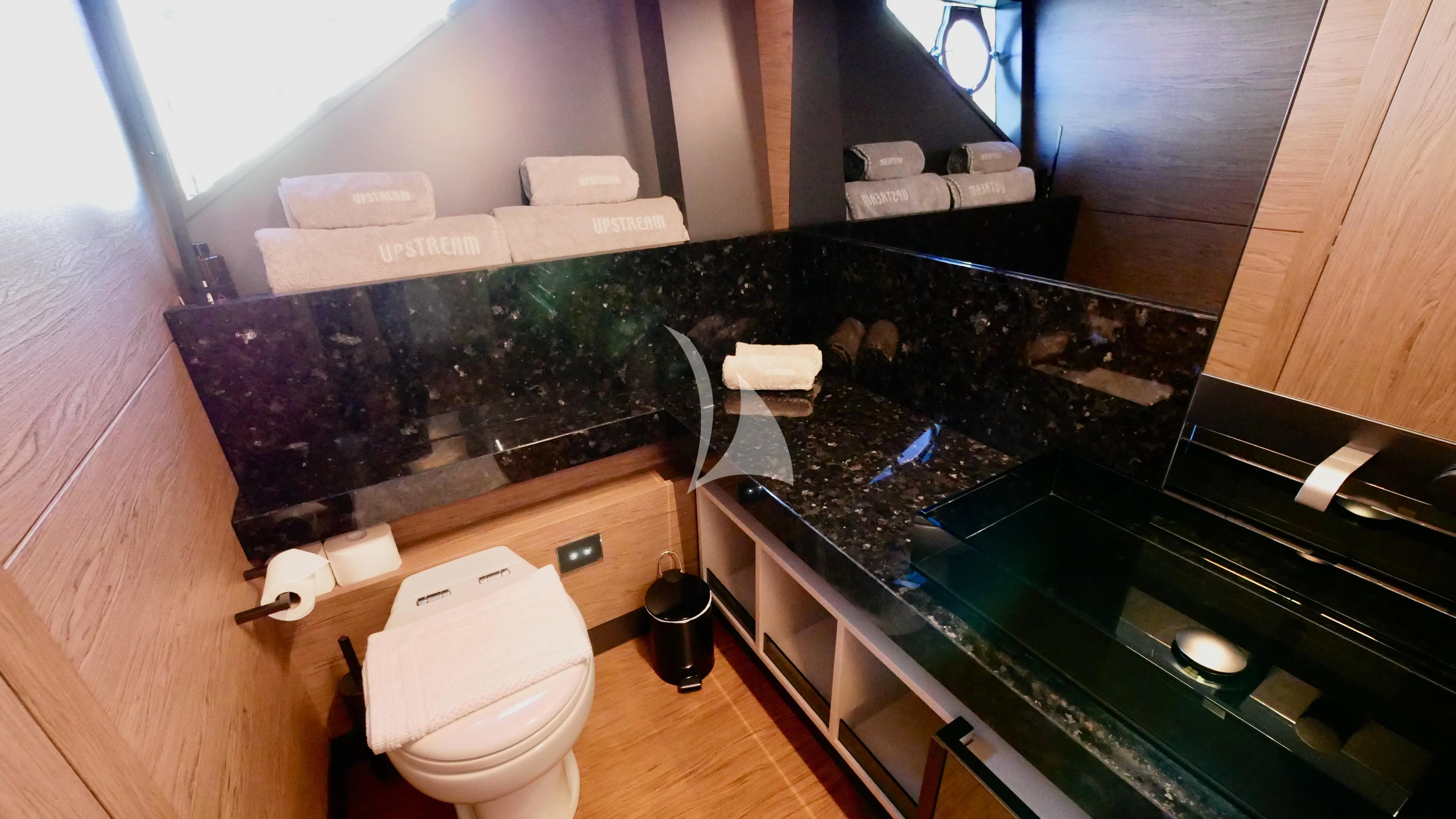 a bathroom with a countertop sink and a toilet aboard NINETEEN Yacht for Sale