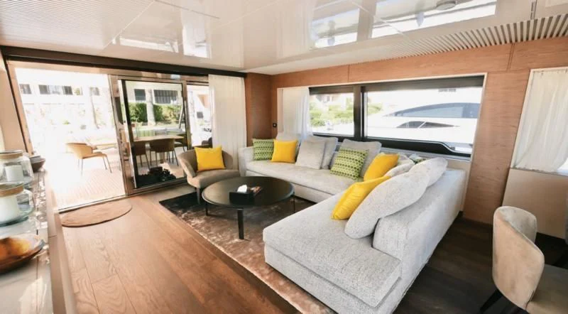a living room with a couch and a table aboard NINETEEN Yacht for Sale