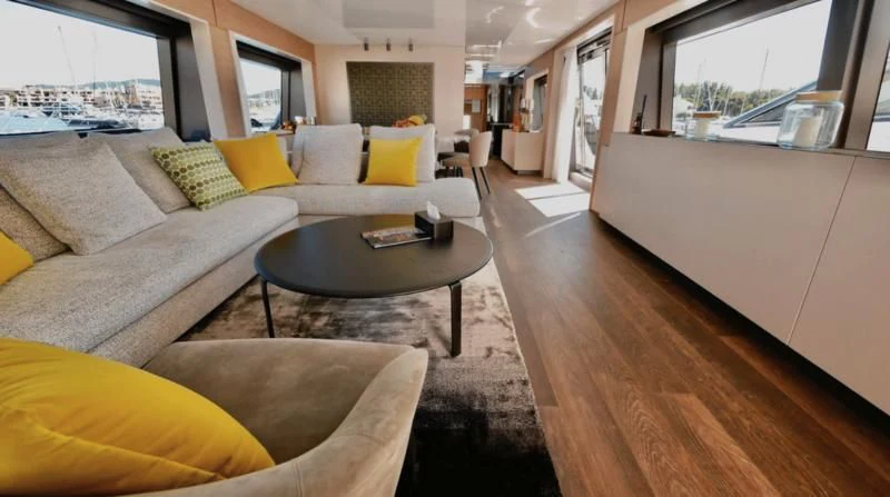 a living room with a couch and a coffee table aboard NINETEEN Yacht for Sale