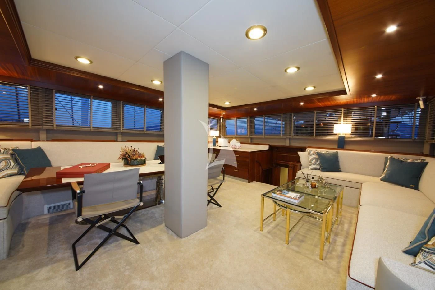 a living room with a large white column and a table with chairs aboard MARE NOSTRUM Yacht for Sale