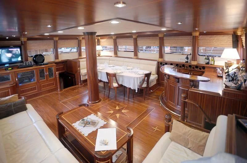 a large room with wood floors and a large television aboard MARE NOSTRUM Yacht for Sale