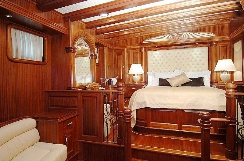 a bedroom with a bed and a chair aboard MARE NOSTRUM Yacht for Sale