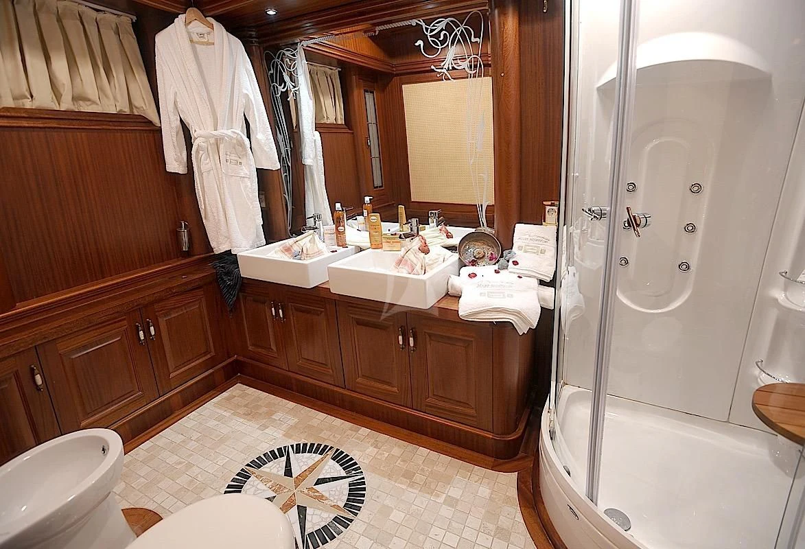 a bathroom with a tub sink and a mirror aboard MARE NOSTRUM Yacht for Sale