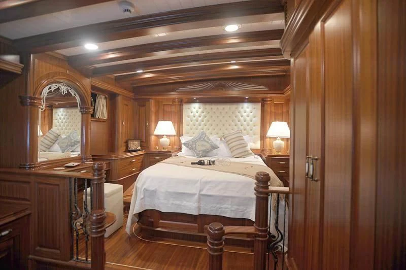 a bedroom with a wood wall aboard MARE NOSTRUM Yacht for Sale
