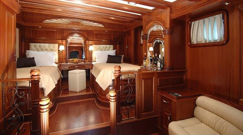 a room with a bed and a mirror aboard MARE NOSTRUM Yacht for Sale