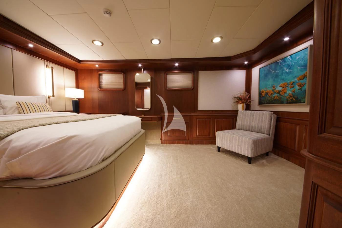 a room with a bed and a chair aboard MARE NOSTRUM Yacht for Sale