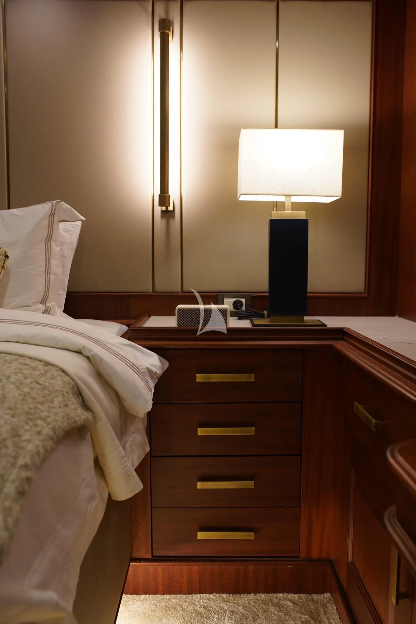 a bedroom with a bed and a lamp aboard MARE NOSTRUM Yacht for Sale