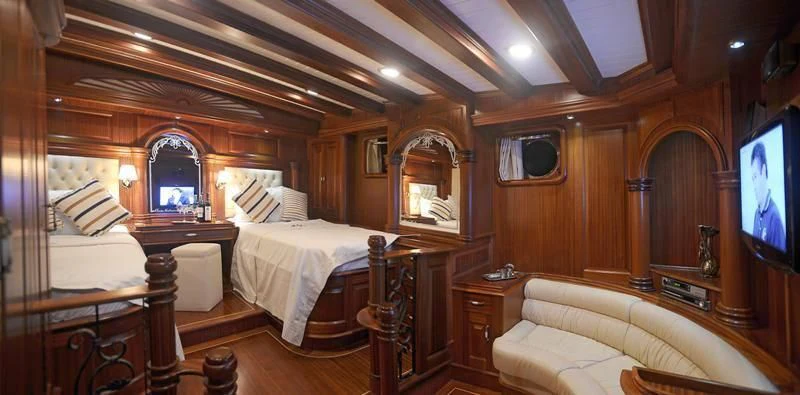 a room with wooden furniture aboard MARE NOSTRUM Yacht for Sale