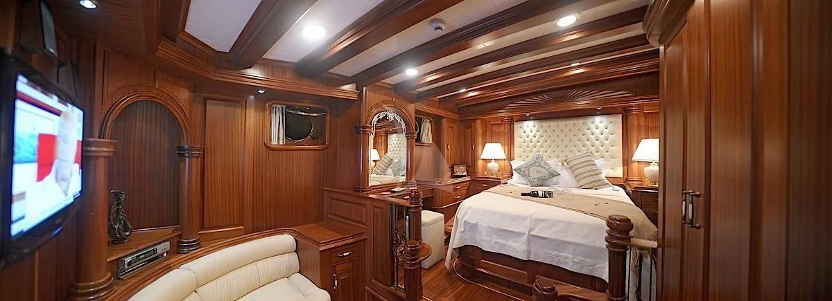 a room with a bed and a television aboard MARE NOSTRUM Yacht for Sale