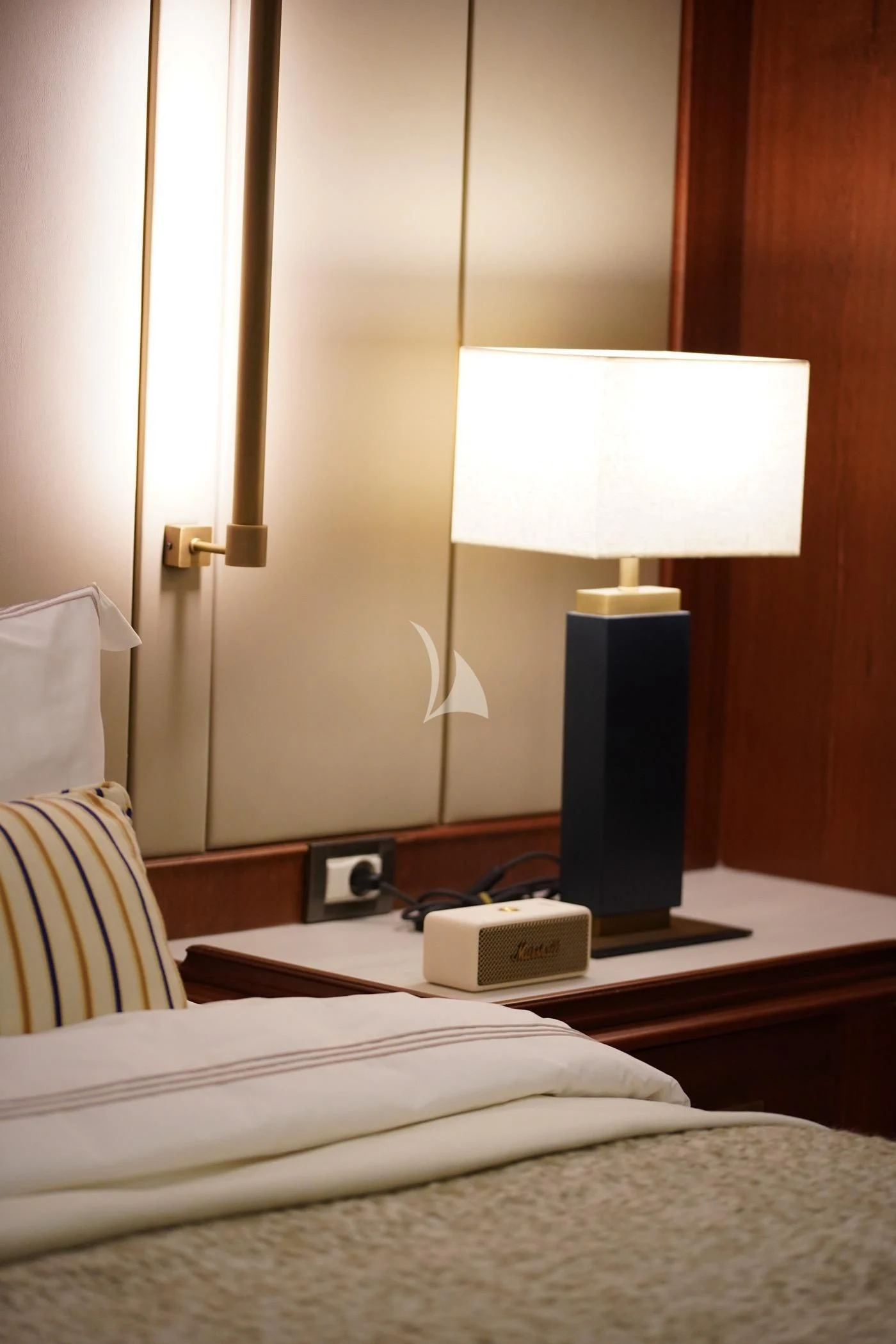 a lamp on a bed aboard MARE NOSTRUM Yacht for Sale