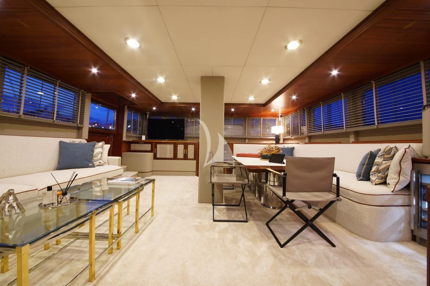 a living room with a large white sofa and a table aboard MARE NOSTRUM Yacht for Sale