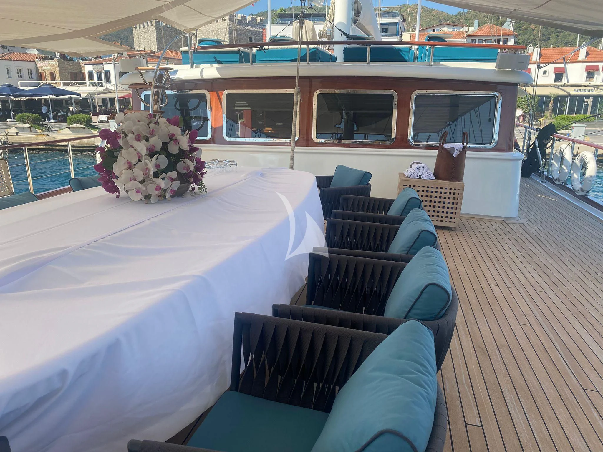 a deck with a table and chairs aboard MARE NOSTRUM Yacht for Sale