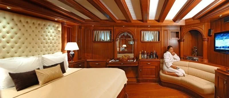 a person sitting on a bed aboard MARE NOSTRUM Yacht for Sale