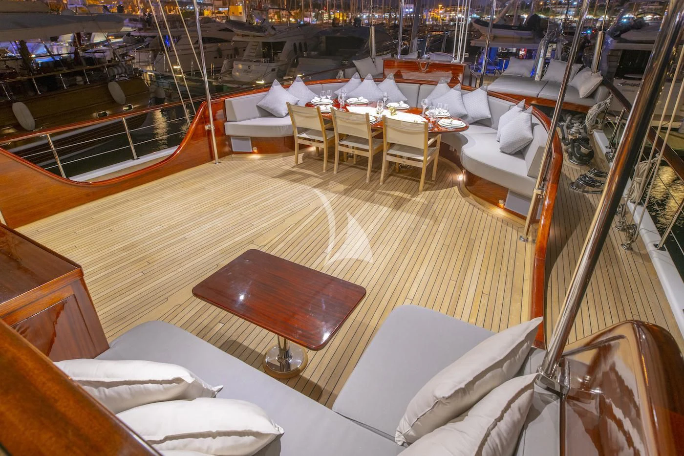 a boat with a table and chairs aboard HIC SALTA Yacht for Sale