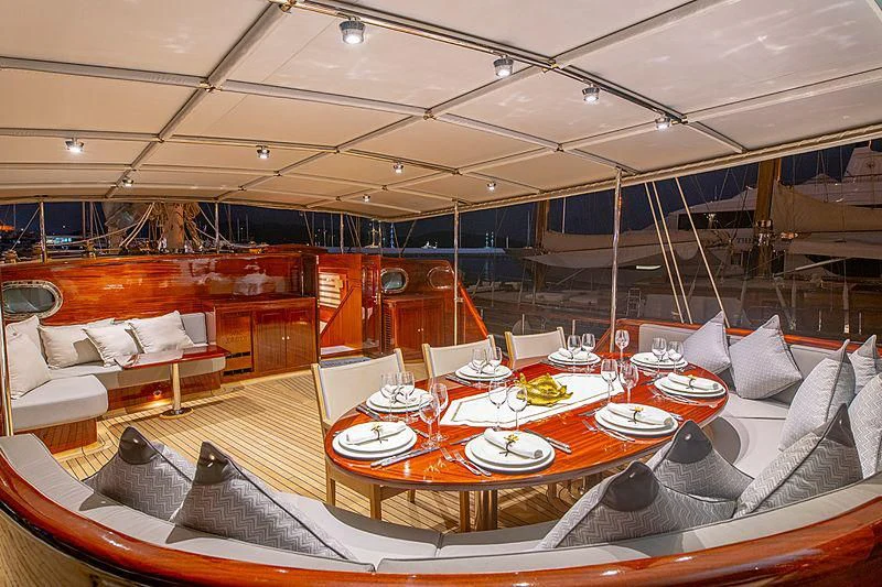 a large room with a table and chairs aboard HIC SALTA Yacht for Sale