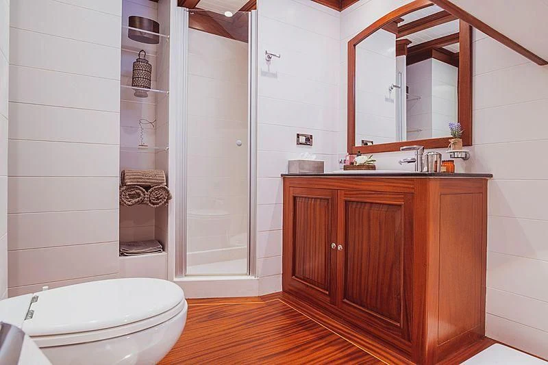 a bathroom with a glass shower aboard HIC SALTA Yacht for Sale
