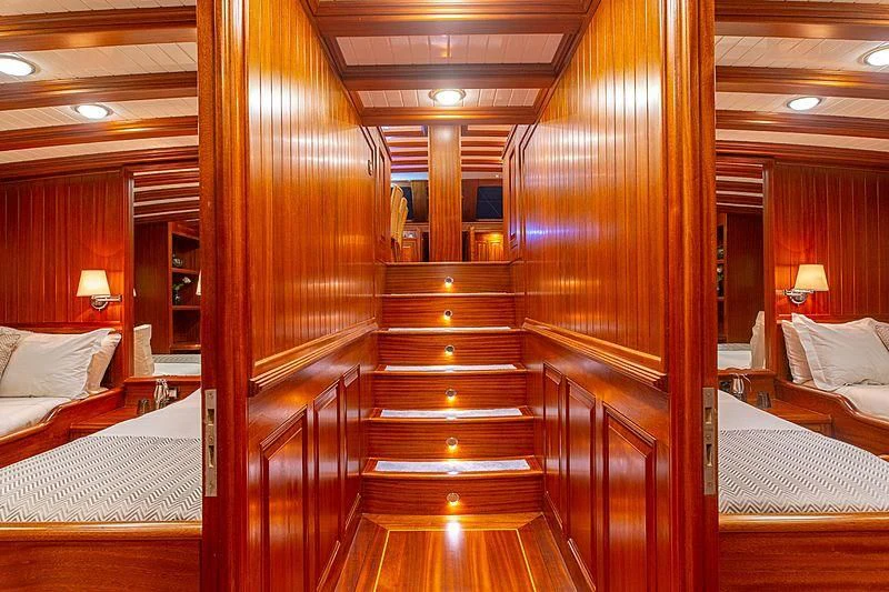 a room with a bed and a wood wall aboard HIC SALTA Yacht for Sale