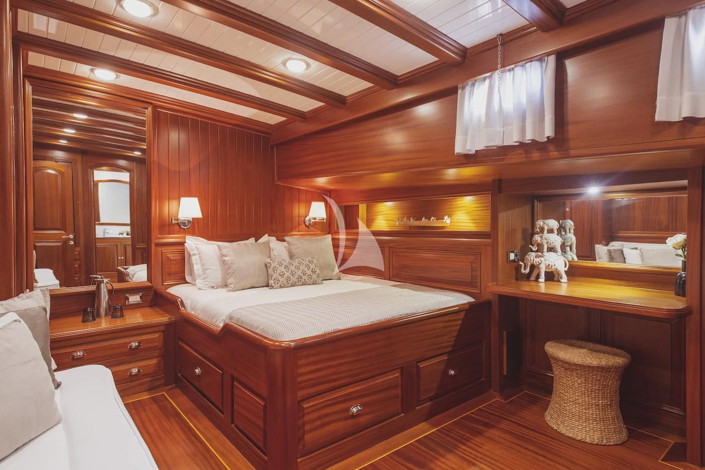 a bedroom with a bed and a mirror aboard HIC SALTA Yacht for Sale