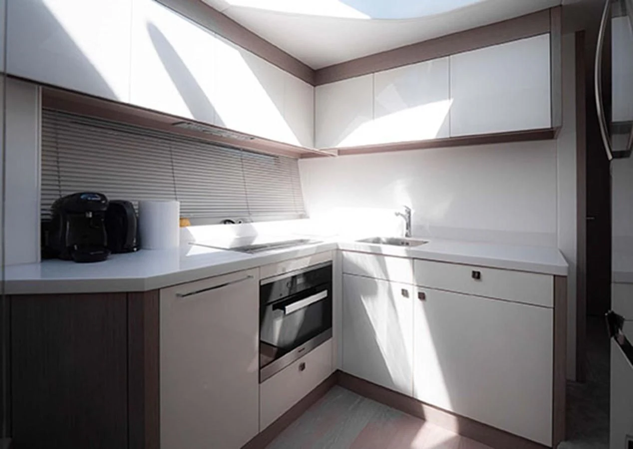 a kitchen with white cabinets aboard VALERIA Yacht for Sale