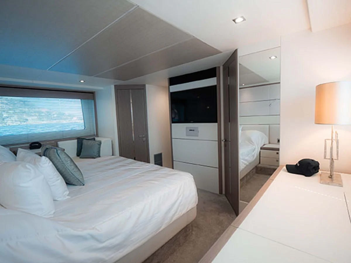 a bedroom with a bed and a television aboard VALERIA Yacht for Sale