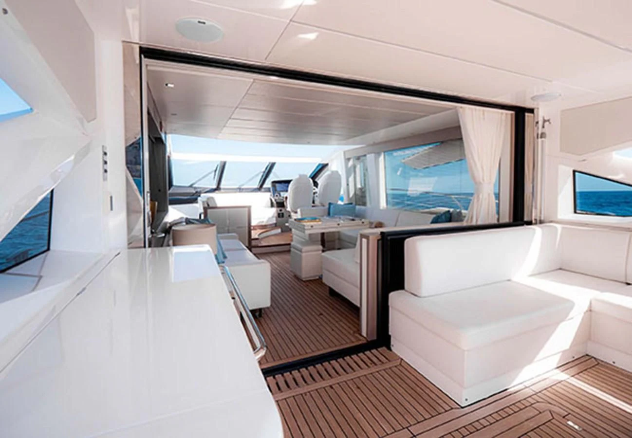 a room with a large window and a table with chairs aboard VALERIA Yacht for Sale