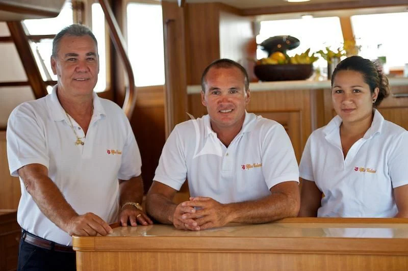 a group of men smiling aboard MISS KULANI Yacht for Charter