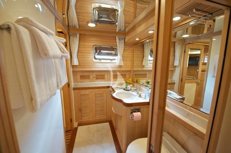 a bathroom with a sink and a mirror aboard MISS KULANI Yacht for Charter