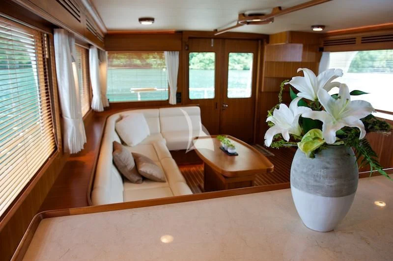 a living room with a couch and a table aboard MISS KULANI Yacht for Charter