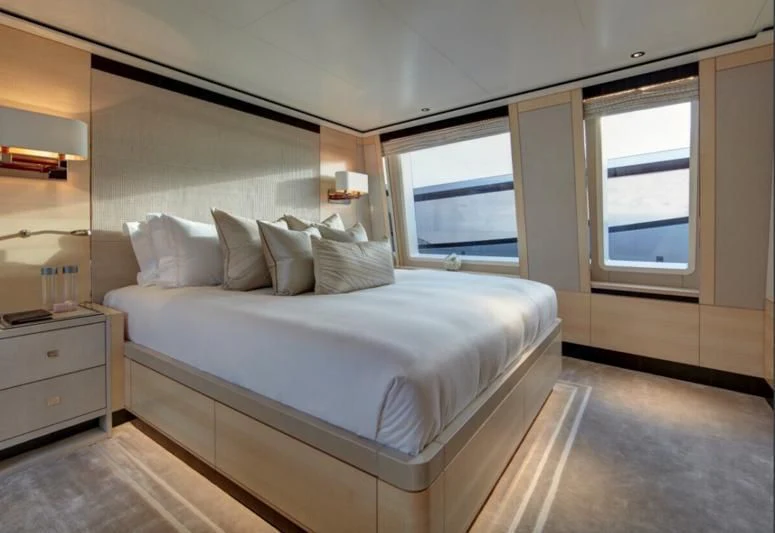 a bedroom with a bed and a window aboard LADY VICTORIA Yacht for Sale