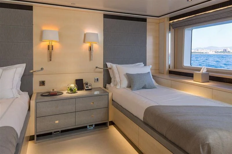 a bedroom with a bed and a window aboard LADY VICTORIA Yacht for Sale
