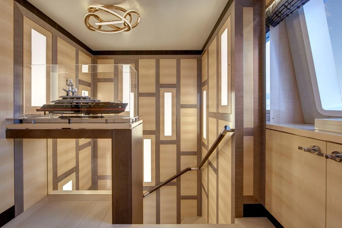 a room with a table and a chandelier aboard LADY VICTORIA Yacht for Sale