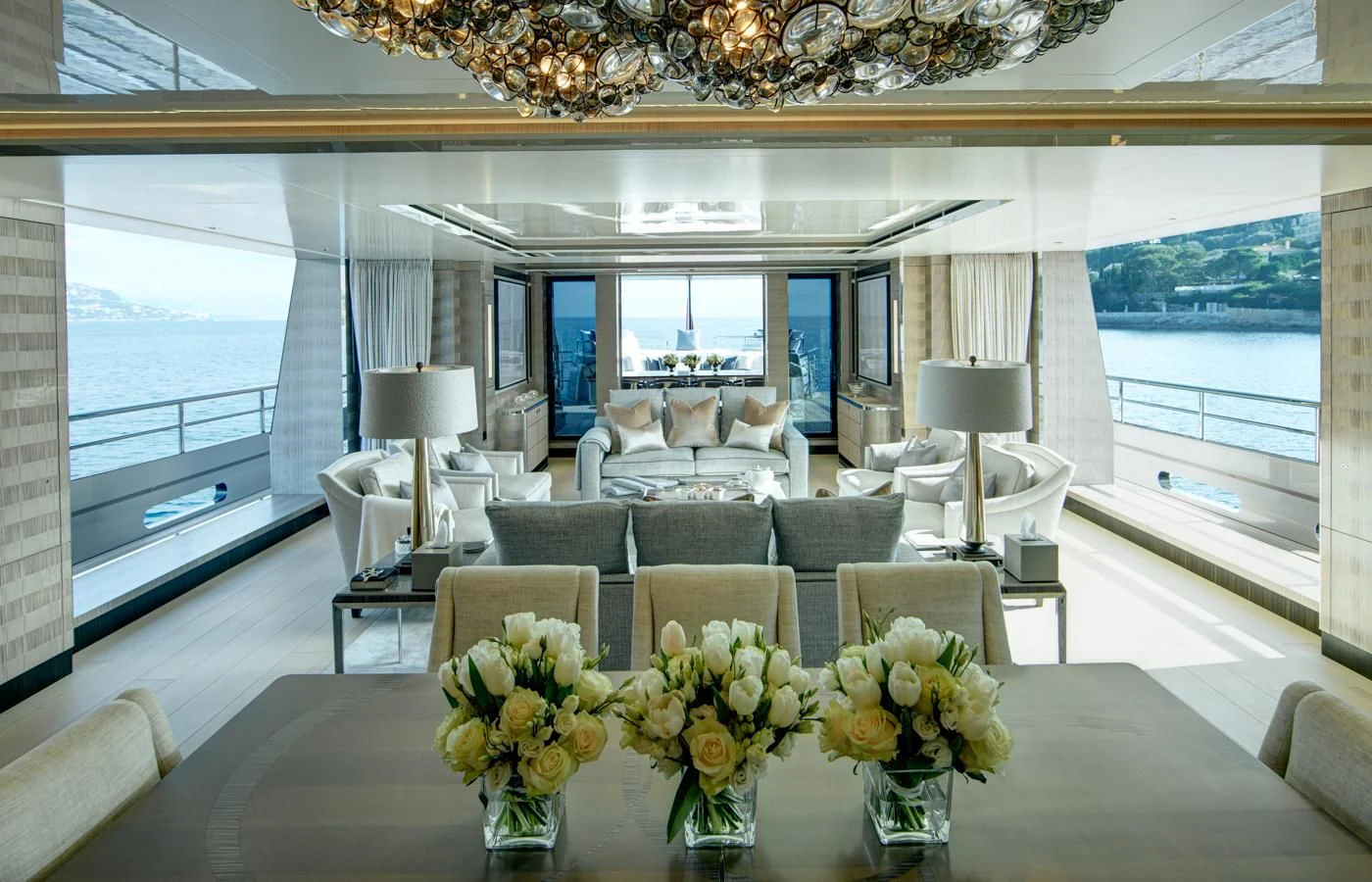 a large room with a table and chairs and a large window aboard LADY VICTORIA Yacht for Sale