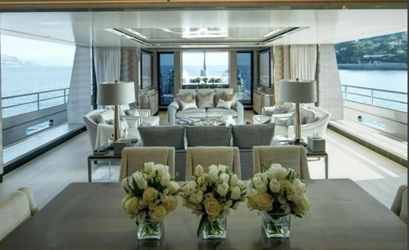 a room with a table chairs and flowers aboard LADY VICTORIA Yacht for Sale