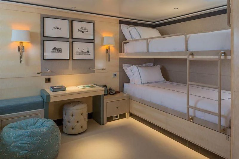 a room with a bed and a desk aboard LADY VICTORIA Yacht for Sale