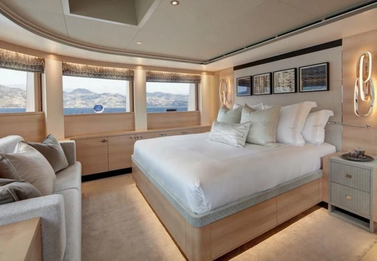 a bedroom with a bed and a couch aboard LADY VICTORIA Yacht for Sale