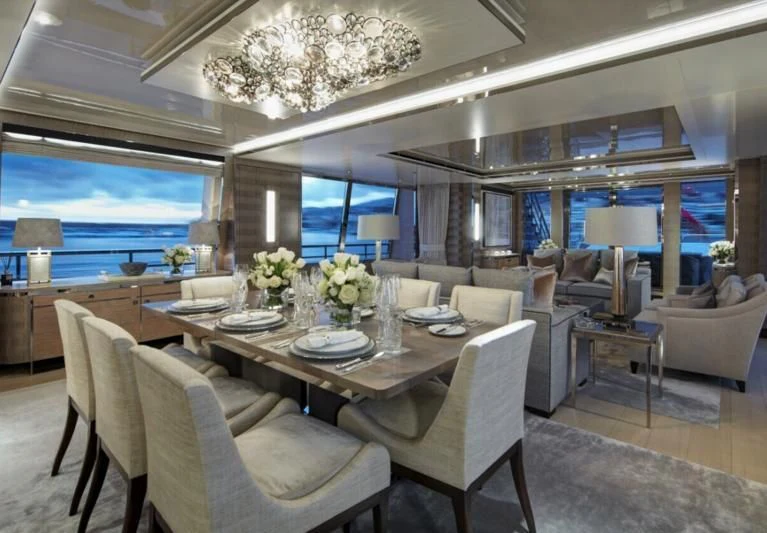 a large living room with a large chandelier aboard LADY VICTORIA Yacht for Sale