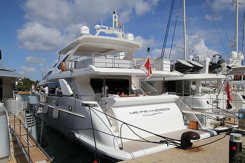 a white boat with a red stripe on the front aboard MR. FRANCISCO Yacht for Sale