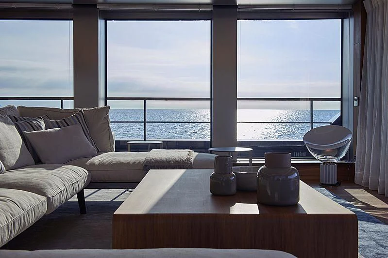 a living room with a large window aboard OCEAN'S FOUR Yacht for Sale