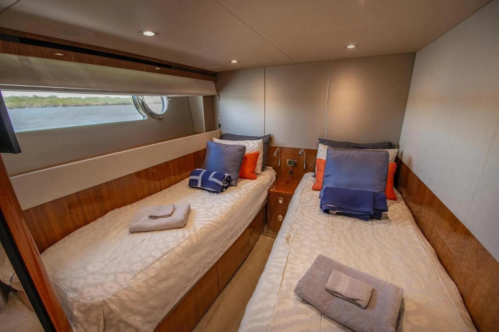 a bedroom with a bed and a window aboard LIQUIDITY Yacht for Sale