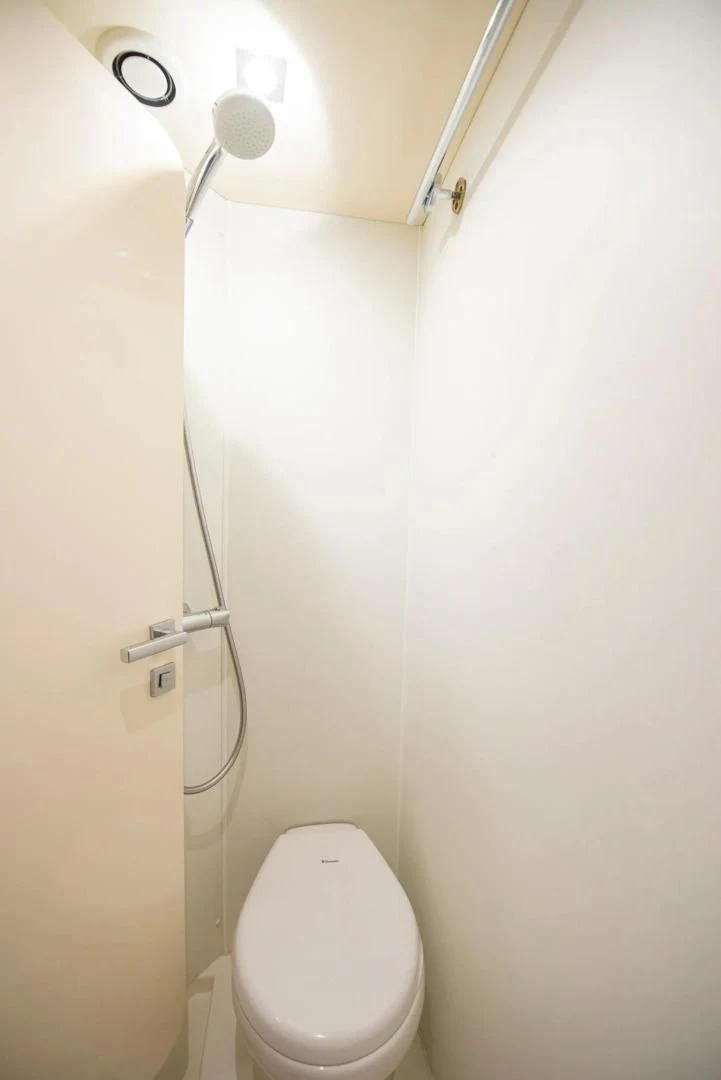 a toilet with a shower head aboard LIQUIDITY Yacht for Sale