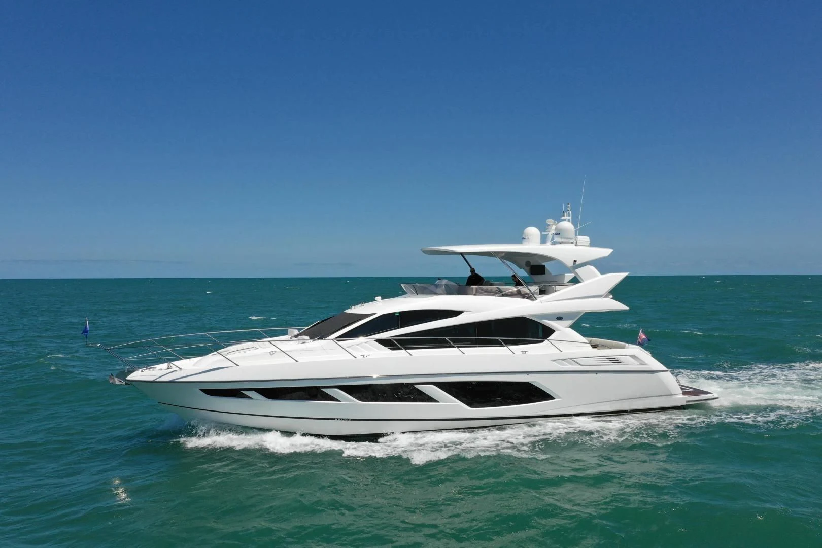a white yacht in the ocean aboard LIQUIDITY Yacht for Sale