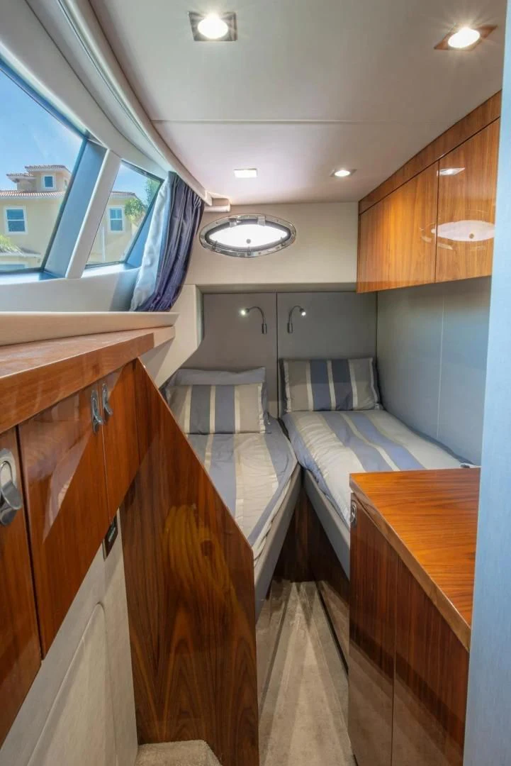 a room with a bed and a desk aboard LIQUIDITY Yacht for Sale