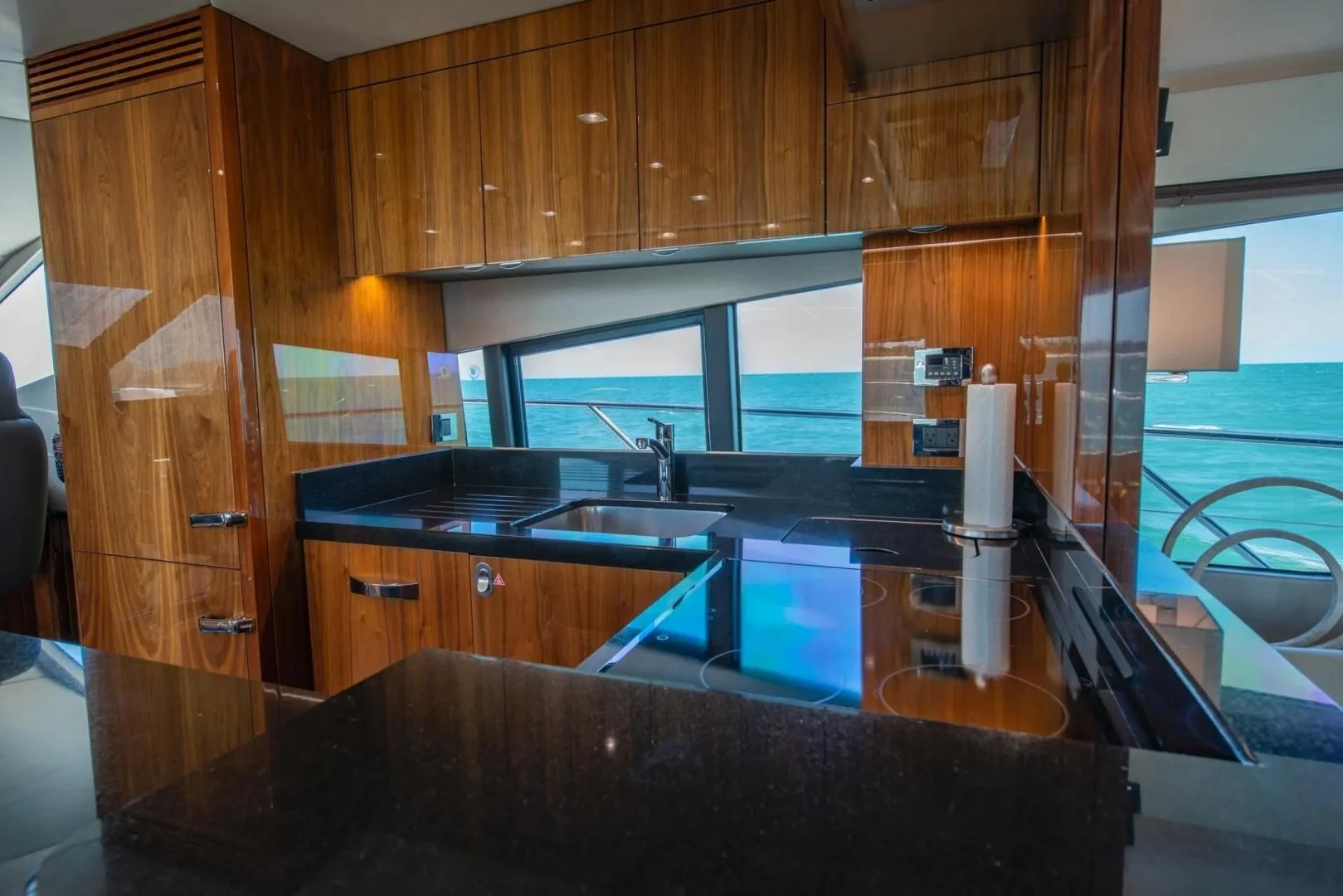 a kitchen with wooden cabinets aboard LIQUIDITY Yacht for Sale