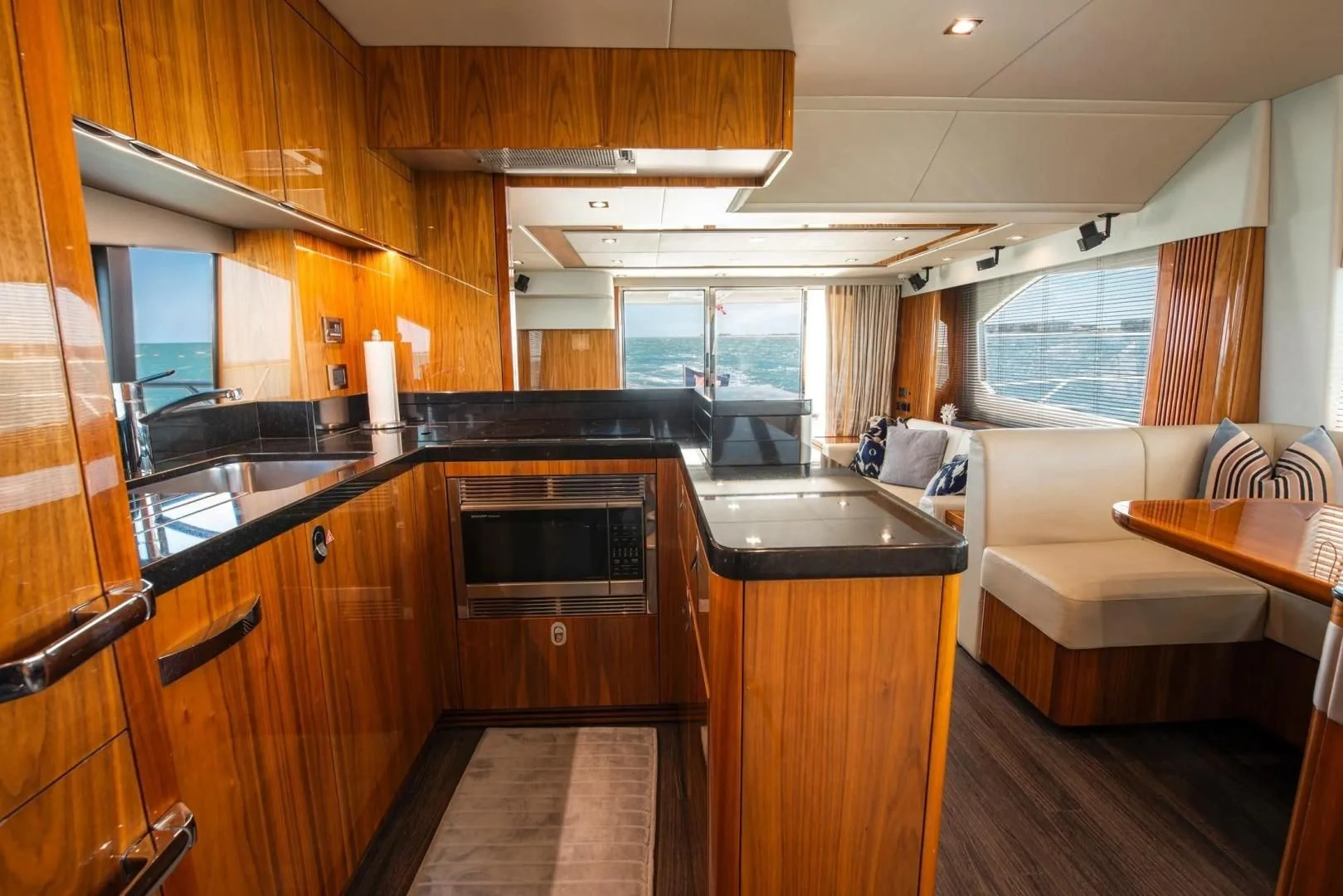 a kitchen with wooden cabinets aboard LIQUIDITY Yacht for Sale