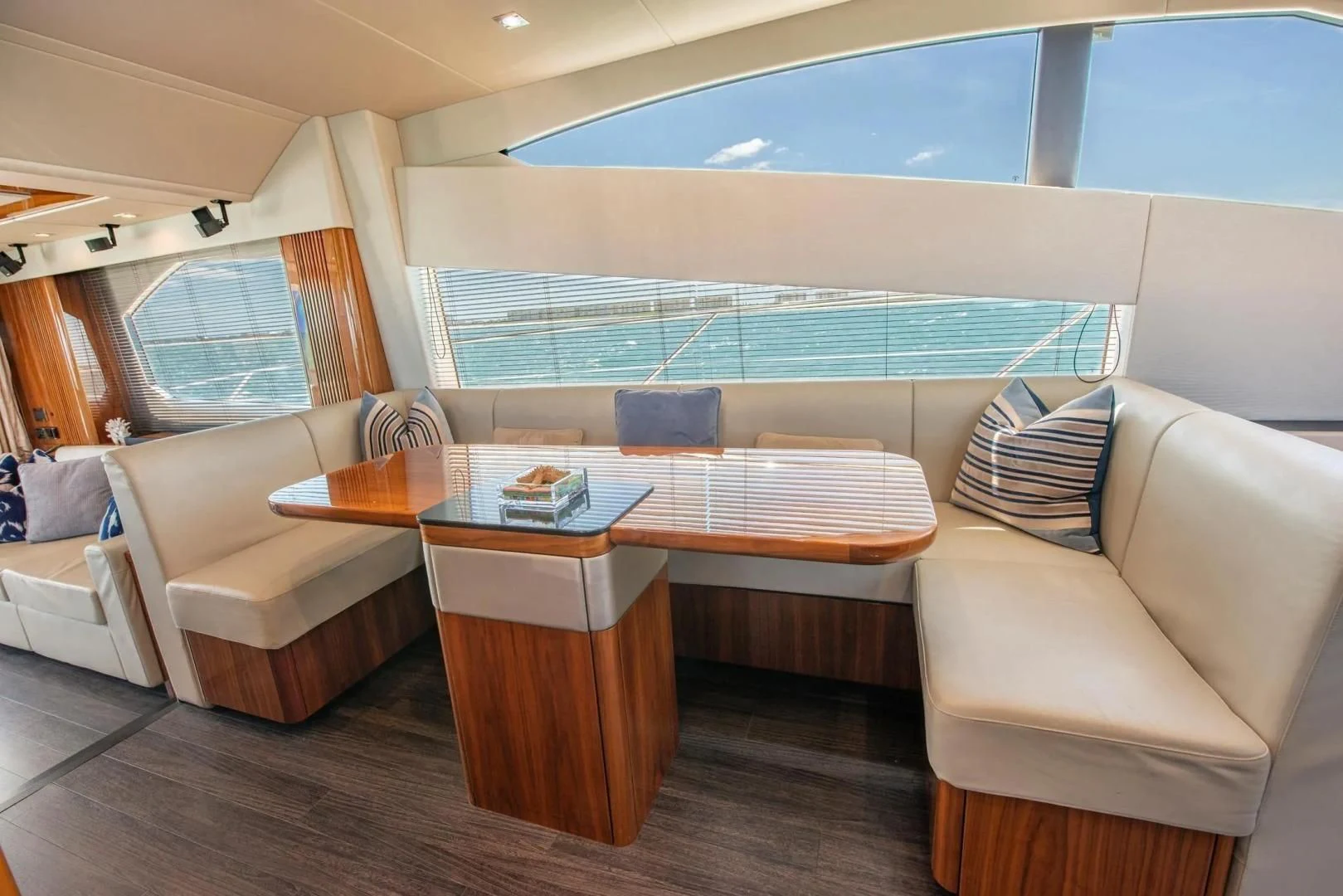 a room with a table and couches aboard LIQUIDITY Yacht for Sale