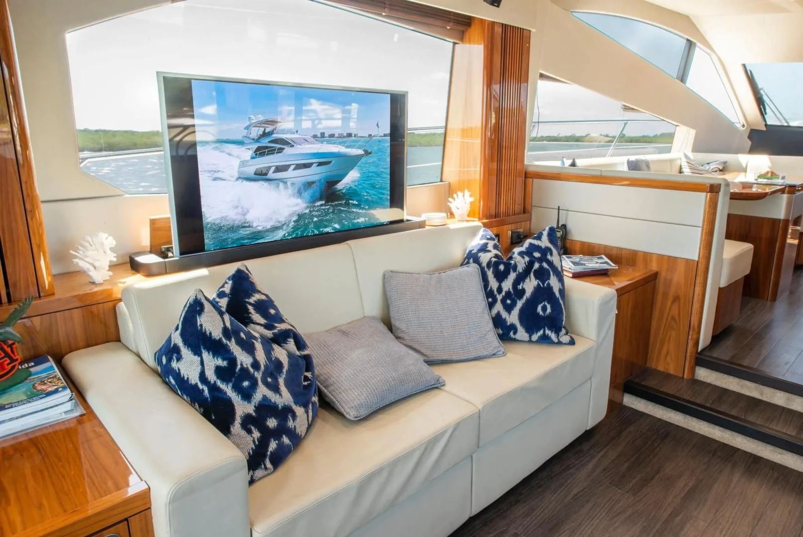 a living room with a large screen aboard LIQUIDITY Yacht for Sale
