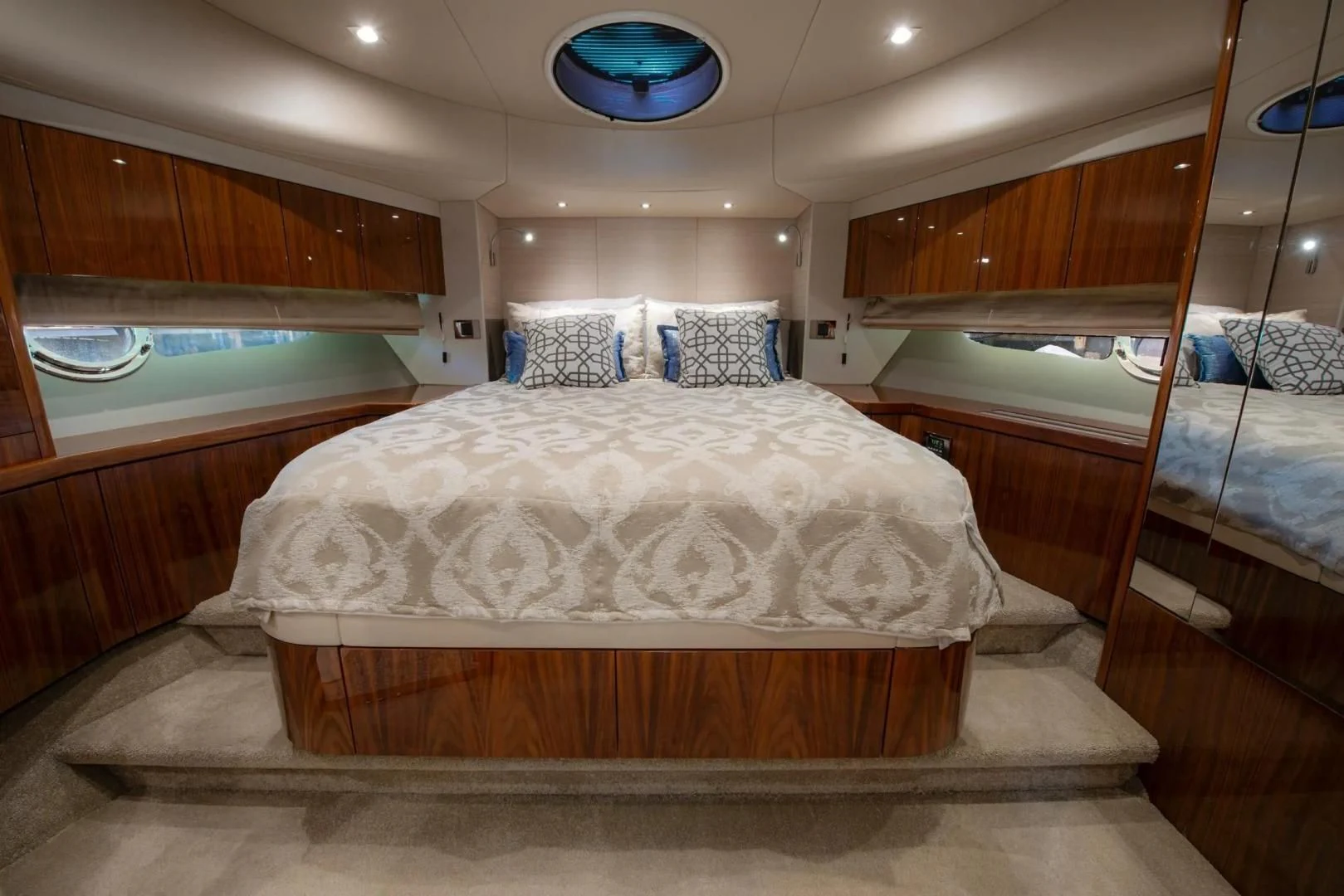 a room with a bed and a mirror aboard LIQUIDITY Yacht for Sale